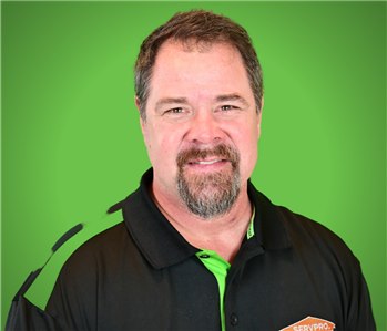 servpro staff infront of a green background